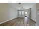 Bright living room with wood-style floors, ceiling fan, and access to outdoor space at 1819 Redmond Brook Ln, Ruskin, FL 33570