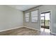 Living room with wood floors, large windows and a screened outdoor patio entrance at 1819 Redmond Brook Ln, Ruskin, FL 33570
