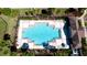 Overhead shot of the community pool with lounge chairs, tables, and lush tropical landscaping at 1819 Redmond Brook Ln, Ruskin, FL 33570