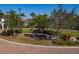 Sarasota National community entrance sign surrounded by lush landscaping and brick-paved road at 23085 Banbury Way # 103, Venice, FL 34293