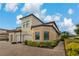 Stunning exterior of condo featuring lush landscaping and brick paver driveway at 23085 Banbury Way # 103, Venice, FL 34293