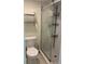 Bathroom featuring a shower with glass doors, a wall mounted rack and a white toilet at 2763 Woodgate Ln # 208, Sarasota, FL 34231