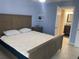 Bedroom featuring a bed, blue walls, and an ensuite bathroom visible through an open door at 2763 Woodgate Ln # 208, Sarasota, FL 34231