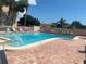 Inviting community pool featuring clear water, lounge areas, and well-kept brick pool deck at 2763 Woodgate Ln # 208, Sarasota, FL 34231