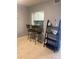 Dining area with breakfast bar, seating, neutral walls, and shelving for decor and functionality at 2763 Woodgate Ln # 208, Sarasota, FL 34231