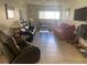 Bright living room featuring tile flooring, three couches, and lots of natural light at 2763 Woodgate Ln # 208, Sarasota, FL 34231