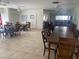 Spacious lounge area with dining tables, chairs, and a comfortable seating area in the background at 2763 Woodgate Ln # 208, Sarasota, FL 34231