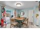 Dining area with a view of the screened patio and pool, plus a wooden table and four chairs at 3158 Regatta Cir, Sarasota, FL 34231