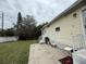 Backyard with a concrete patio, small grill, and green lawn at 3333 26Th E Ave # 1025, Bradenton, FL 34208