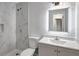 Modern bathroom showcasing a stylish vanity, an LED-lit mirror, and a pristine marble-tiled shower at 3389 Dunbar St, Port Charlotte, FL 33948