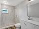 Updated bathroom with a sleek vanity, tiled shower, pebble floor, and modern fixtures at 3389 Dunbar St, Port Charlotte, FL 33948
