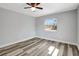 Bedroom features new floors, ceiling fan, natural light from the window, and neutral paint at 3389 Dunbar St, Port Charlotte, FL 33948