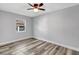 Inviting bedroom with wood-look floors and a window offering natural light at 3389 Dunbar St, Port Charlotte, FL 33948