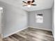 Comfortable bedroom with gray flooring, a ceiling fan, and a window providing great natural light at 3389 Dunbar St, Port Charlotte, FL 33948