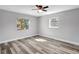 Bedroom showcases new floors, neutral paint, a ceiling fan and natural light from two windows at 3389 Dunbar St, Port Charlotte, FL 33948