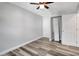 Neutral bedroom with gray flooring, ceiling fan, and built in closet and storage at 3389 Dunbar St, Port Charlotte, FL 33948