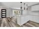 Bright kitchen features stainless steel appliances, white cabinets and a breakfast bar at 3389 Dunbar St, Port Charlotte, FL 33948