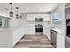 Bright kitchen features stainless steel appliances, white cabinets and a breakfast bar at 3389 Dunbar St, Port Charlotte, FL 33948