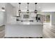Bright kitchen features stainless steel appliances, white cabinets, and backyard access at 3389 Dunbar St, Port Charlotte, FL 33948