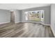 Open-concept living room with laminate flooring, large bay windows with great neighborhood views at 3389 Dunbar St, Port Charlotte, FL 33948