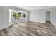 Spacious living room filled with natural light from a large bay window and stylish flooring at 3389 Dunbar St, Port Charlotte, FL 33948