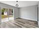 Bright, airy living room with modern gray flooring, backyard shed view through sliding glass door at 3389 Dunbar St, Port Charlotte, FL 33948