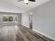 Bright living room features new floors, modern ceiling fan, fresh paint and large windows at 3389 Dunbar St, Port Charlotte, FL 33948