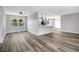 Open living space with hardwood floors leads to a modern kitchen with natural light at 3389 Dunbar St, Port Charlotte, FL 33948
