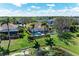 An aerial view of the property, showcasing the private pool and lush backyard overlooking the tranquil pond at 368 Snapdragon Loop, Bradenton, FL 34212