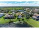 Aerial shot of the community with lake view, swimming pool, and well-manicured lawns at 368 Snapdragon Loop, Bradenton, FL 34212