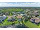 Aerial view of a charming home with a pool and surrounded by lush greenery, providing a serene retreat at 368 Snapdragon Loop, Bradenton, FL 34212