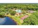 Aerial view showcasing community amenities including pool, playground, tennis and basketball courts, plus a lake at 368 Snapdragon Loop, Bradenton, FL 34212