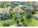 Aerial view of home featuring screened-in pool, lush landscaping, and well-manicured lawn at 368 Snapdragon Loop, Bradenton, FL 34212