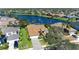 Aerial view of house showcasing lush landscaping, lake view, and paved driveway at 368 Snapdragon Loop, Bradenton, FL 34212