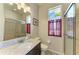 Modern bathroom featuring a granite vanity, a tiled shower, and a decorative window with bright light at 368 Snapdragon Loop, Bradenton, FL 34212
