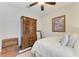 Comfortable bedroom with hardwood floors, a ceiling fan, and a vintage dresser at 368 Snapdragon Loop, Bradenton, FL 34212