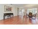 Bright dining room with hardwood floors, a chandelier, and a view of the front yard at 368 Snapdragon Loop, Bradenton, FL 34212