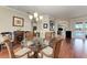 Bright dining space with hardwood floors, archways, and a view of the pool area at 368 Snapdragon Loop, Bradenton, FL 34212
