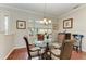 Cozy dining area with hardwood floors, a glass-topped table, and elegant chairs at 368 Snapdragon Loop, Bradenton, FL 34212