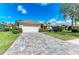 View of house and driveway, including lawn, shrubs and trees at 368 Snapdragon Loop, Bradenton, FL 34212