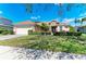 Charming home featuring manicured landscaping, a stone facade, a two-car garage, and a welcoming entrance at 368 Snapdragon Loop, Bradenton, FL 34212