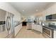 Open-concept kitchen with stainless appliances, granite counters, and view of the living space at 368 Snapdragon Loop, Bradenton, FL 34212