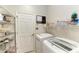 Functional laundry room with modern appliances and ample storage on wire shelving, and a white door at 368 Snapdragon Loop, Bradenton, FL 34212