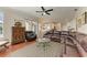 Large open living area with a leather sectional, glass table, and view of the dining and kitchen areas at 368 Snapdragon Loop, Bradenton, FL 34212