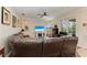 Spacious living room featuring a comfortable leather sectional, fireplace, and views of the lanai at 368 Snapdragon Loop, Bradenton, FL 34212