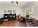A well-lit office space with hardwood floors, a desk, bookcases, and a comfortable leather chair at 368 Snapdragon Loop, Bradenton, FL 34212