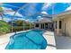 A gorgeous screened pool area featuring a large pool and comfortable seating for relaxing and entertaining at 368 Snapdragon Loop, Bradenton, FL 34212