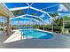 Beautiful screened-in pool with lush landscaping and a serene lake view providing the perfect backyard oasis at 368 Snapdragon Loop, Bradenton, FL 34212