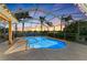Sparkling pool with a screened enclosure is surrounded by lush landscaping and ample patio space at 368 Snapdragon Loop, Bradenton, FL 34212