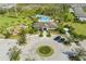 Aerial view of community clubhouse and pool with mature landscaping and ample parking at 3708 Wayfarer Way, Palmetto, FL 34221